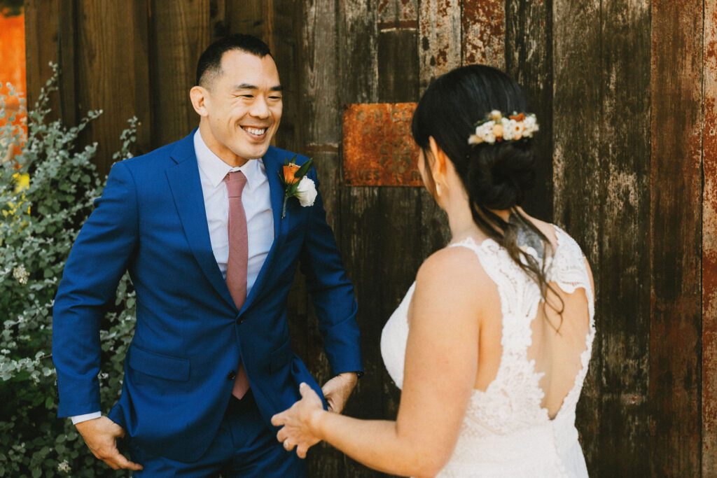 Groom smiles at Bride during First Look at Stemple Creek Ranch