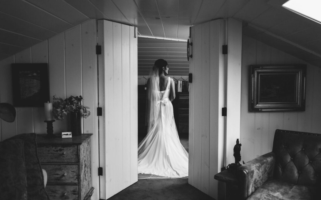A bridal portrait of Bride that's in a clean unique getting ready space that shows amazing wedding photos