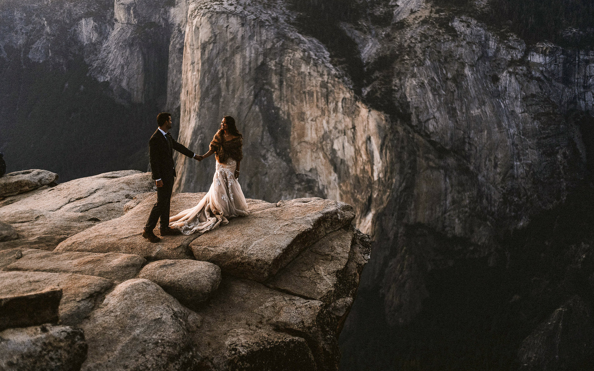 Elopement Photo of bride and Groom holding hands at taft point during sunset