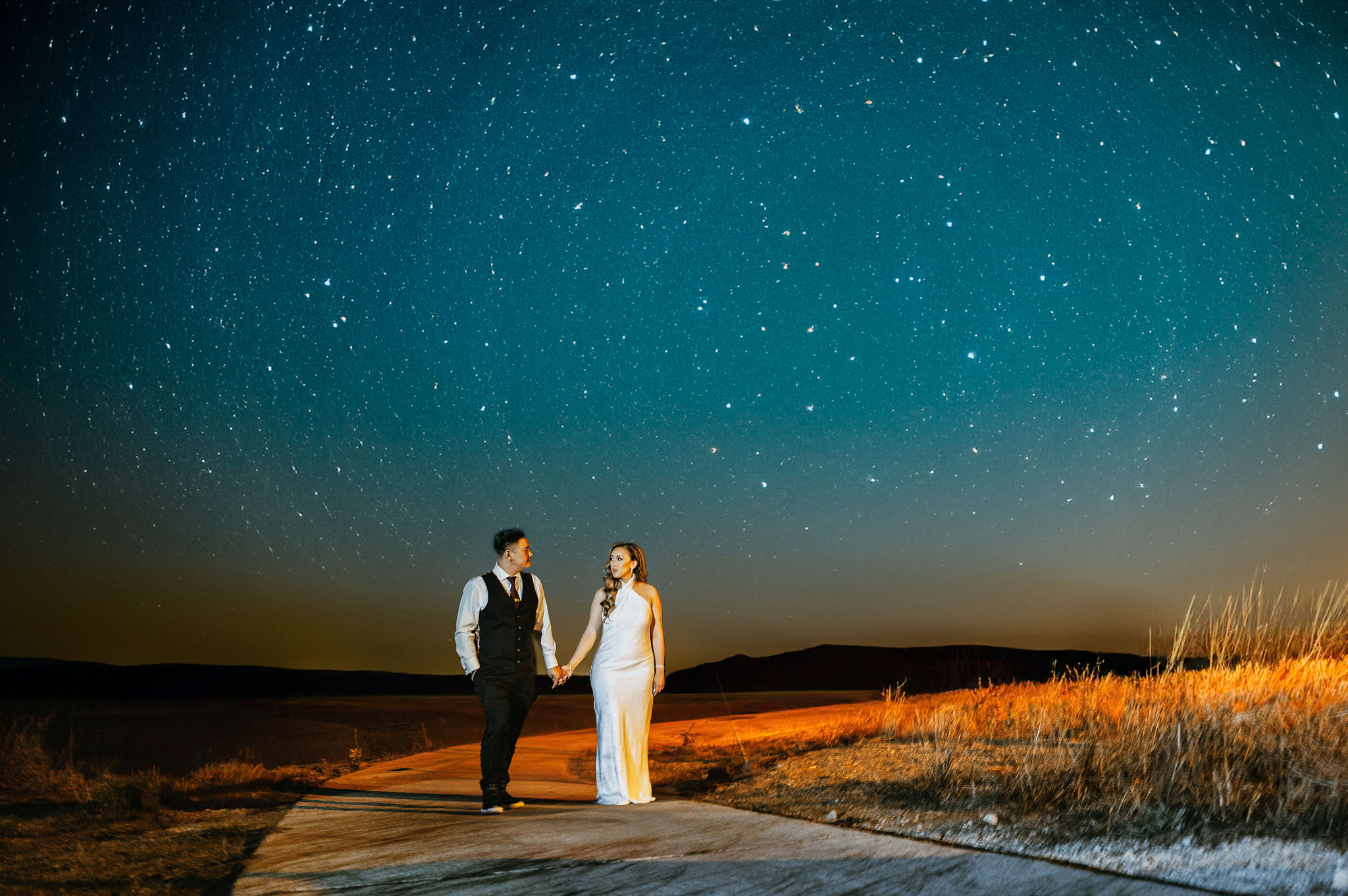 bride and groom holding hands under the stars during a san francisco wedding.