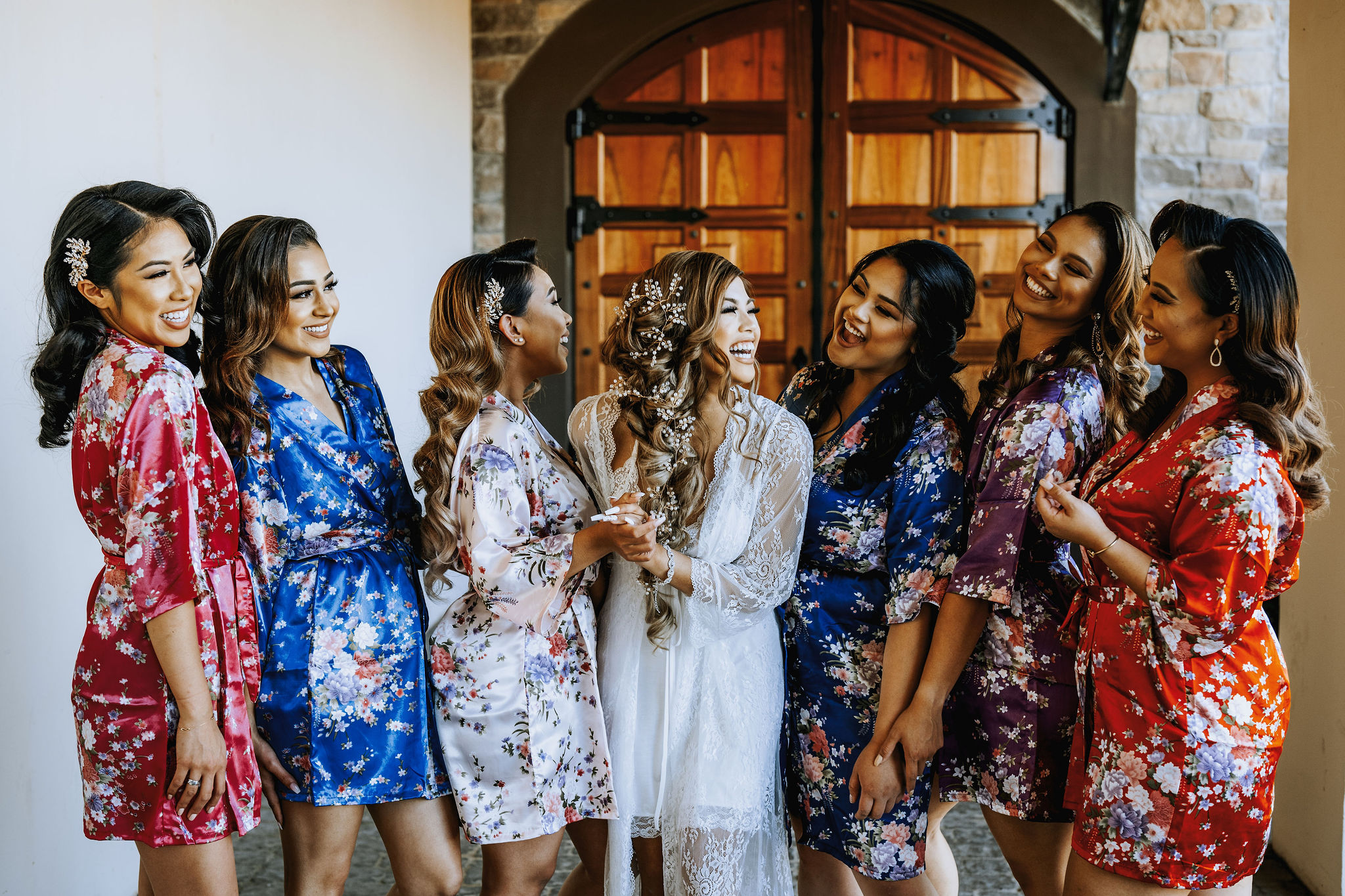 bride laughing with bridesmaids in robes at Ruby Hills Winery in Livermore, California