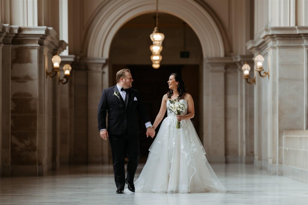 Bride and groom portrait in window light inside San Francisco City Hall