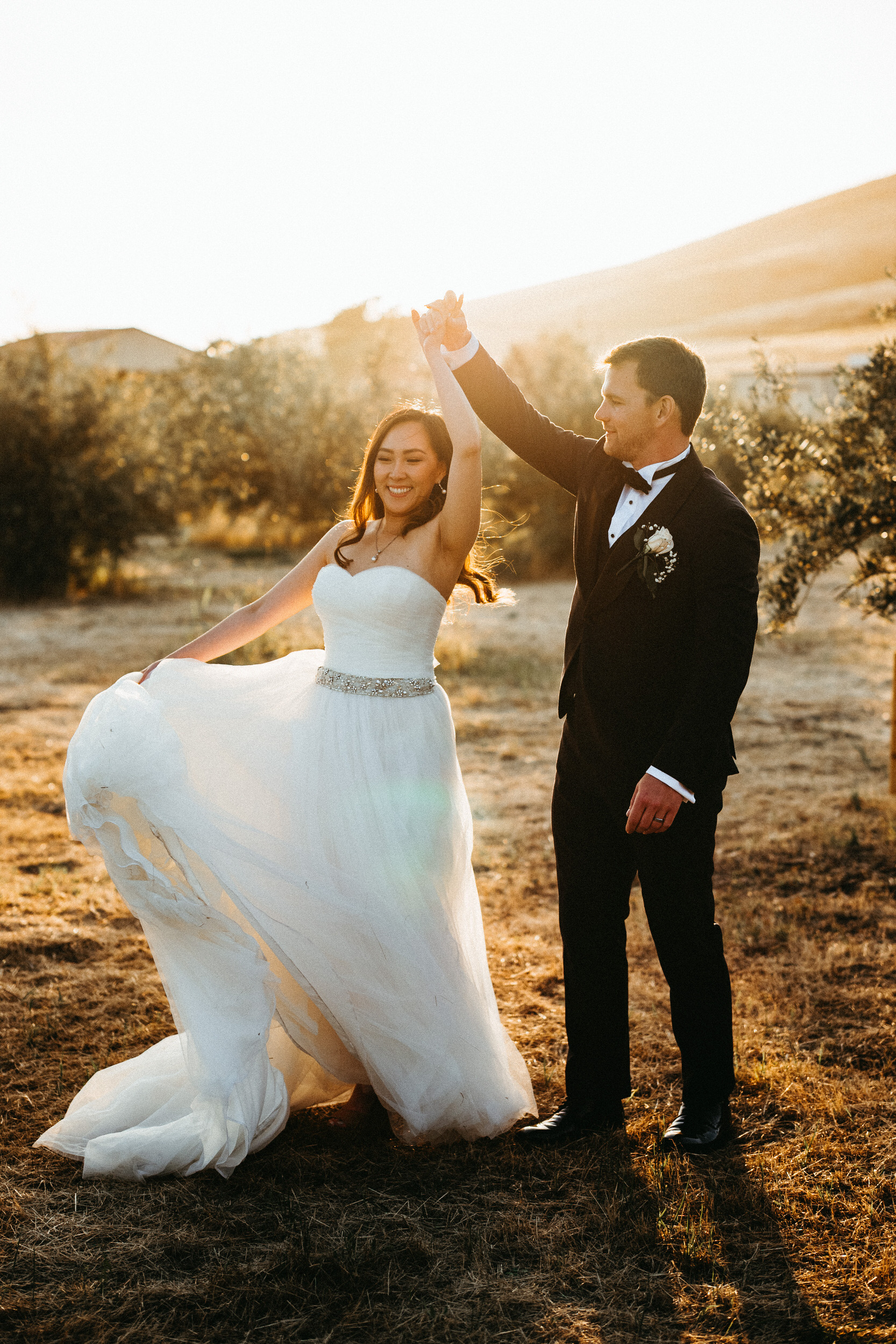 groom spins bride during sunsetat purple orchid in livermore ca