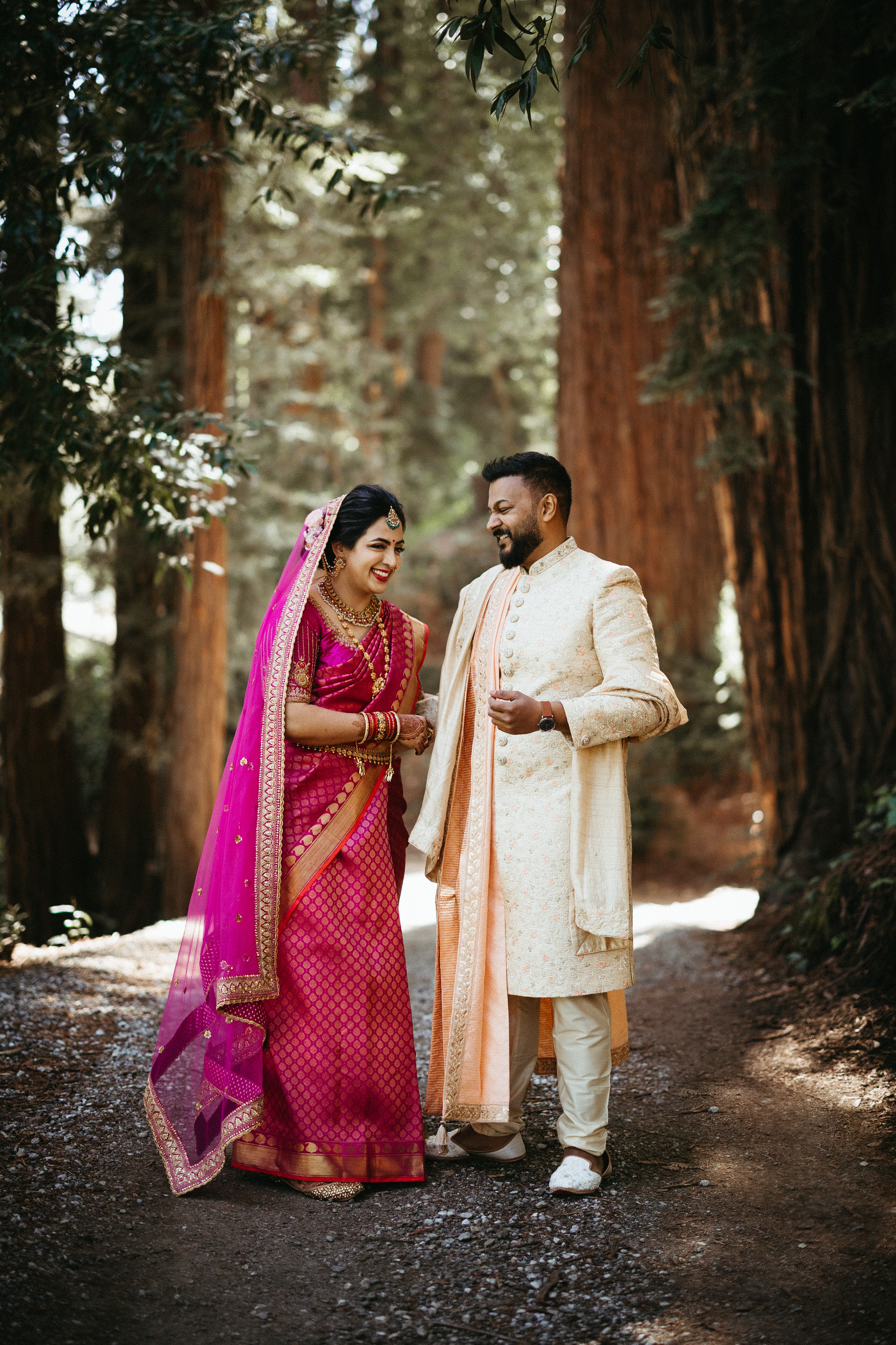 Couple laughing together during Indian wedding in the redwoods at Nestldown in Los Gatos