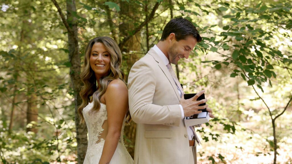 Bride and groom smiling during a private gift exchange before their ceremony at Carolina Country Weddings