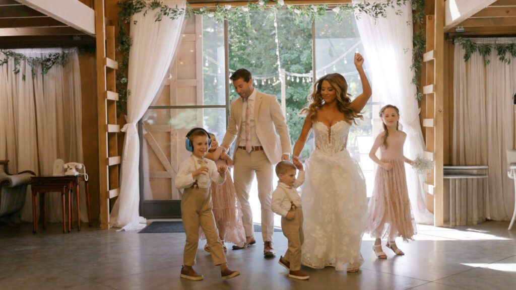 Bride and groom making their grand entrance with their children at Carolina Country Weddings in Mount Pleasant North Carolina